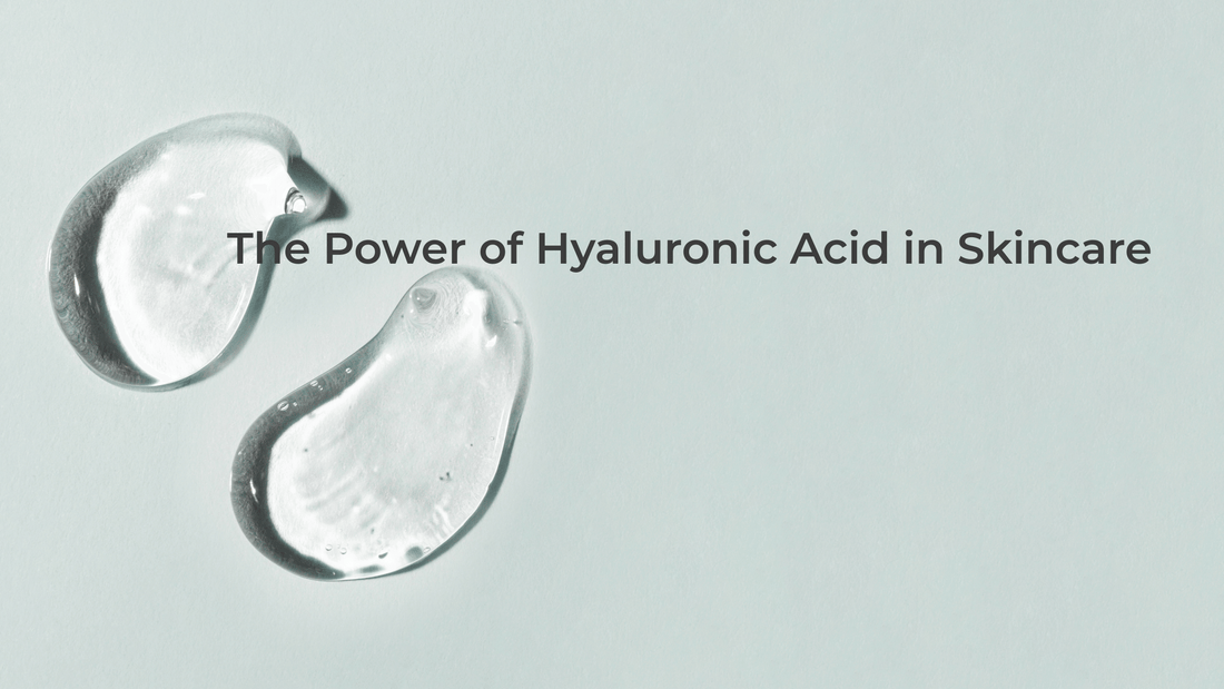 Two transparent serum drops on a pastel blue surface, representing hyaluronic acid’s hydrating power and clean formulation.